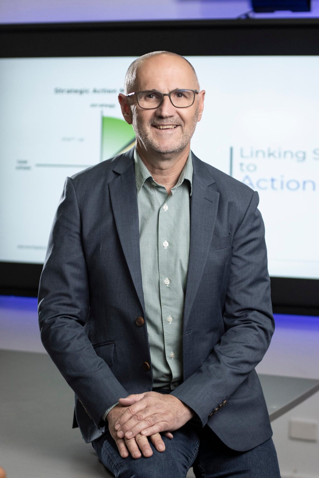 Rod Smith sits in front of a strategy presentation screen at People Management Partners.